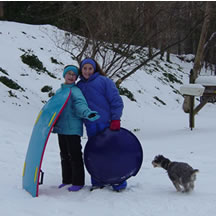 Sorena and Marissa pause in their sledding to post for a picture