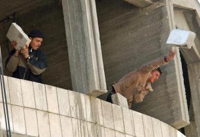 palestinians throwing chunks of cement